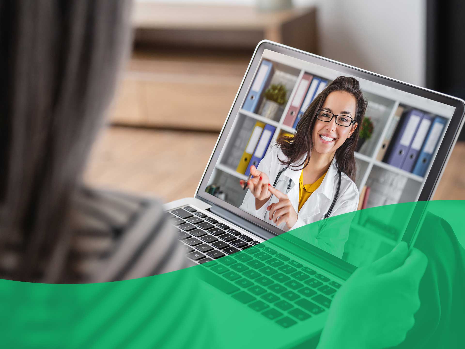 doctor smiling on a screen during a virtual call
