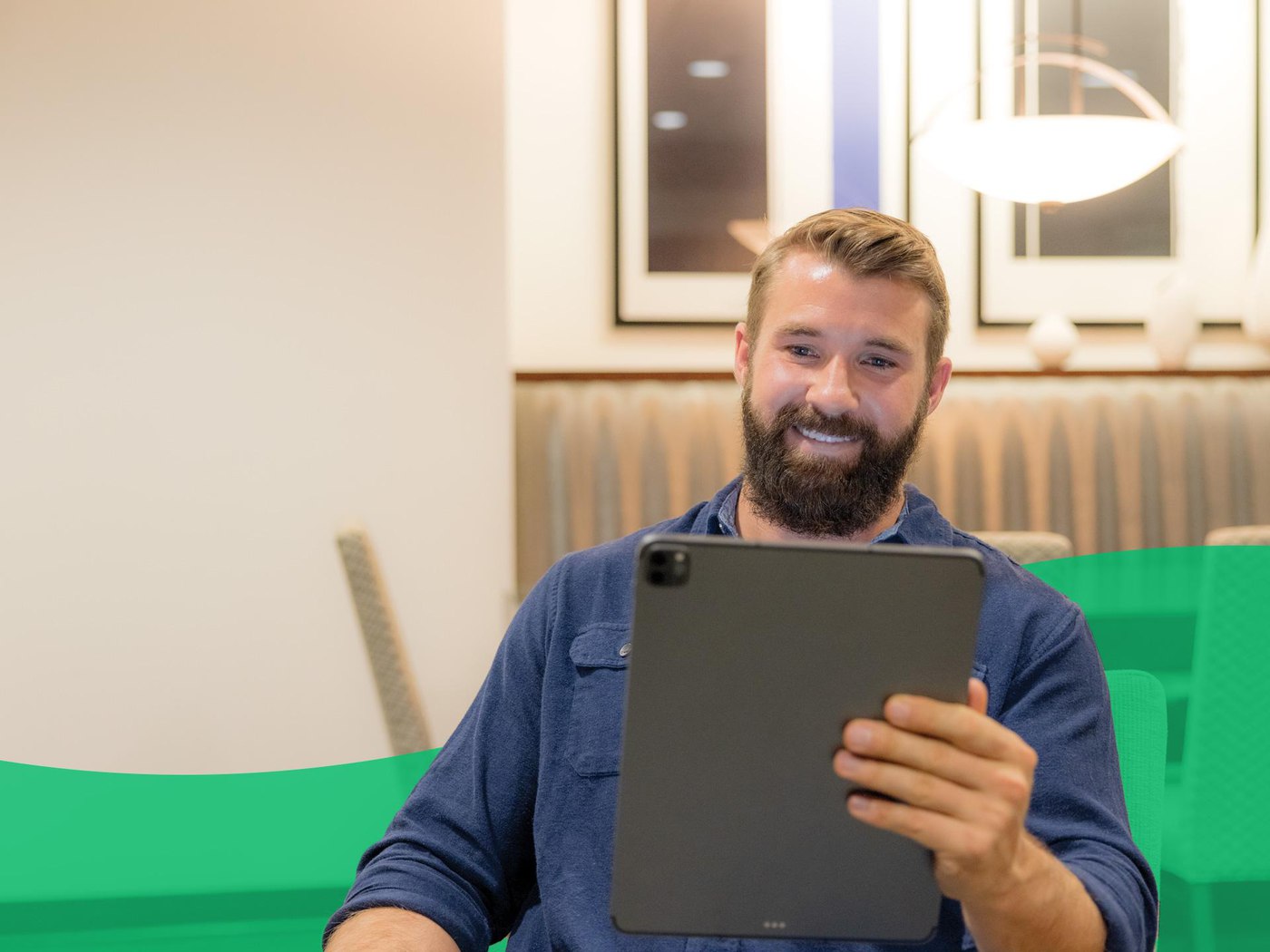 guy smiling looking at tablet