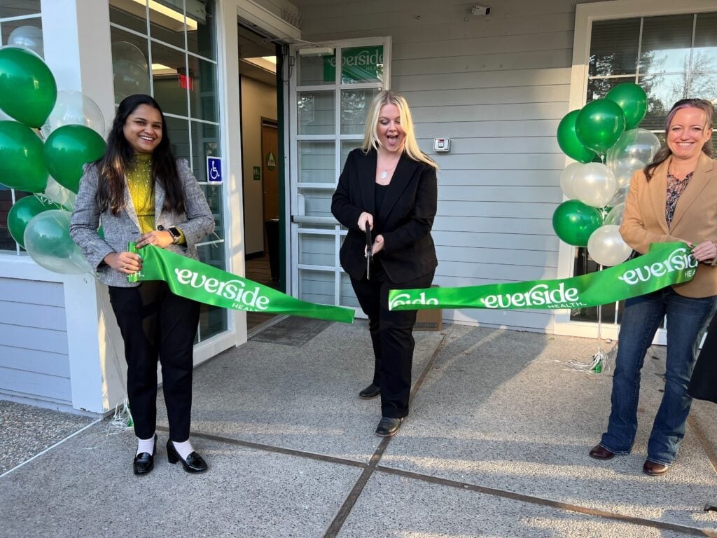 green ribbon cutting in front of new everside health center