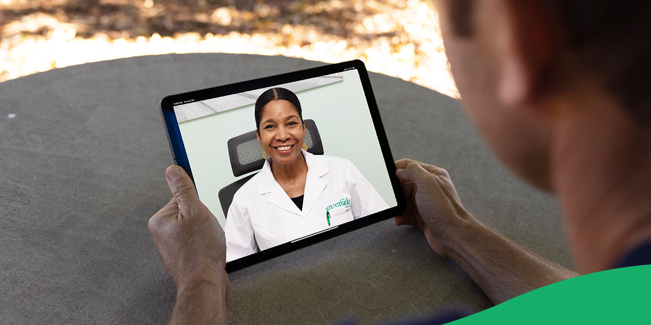 physician smiling on a virtual call on a tablet device